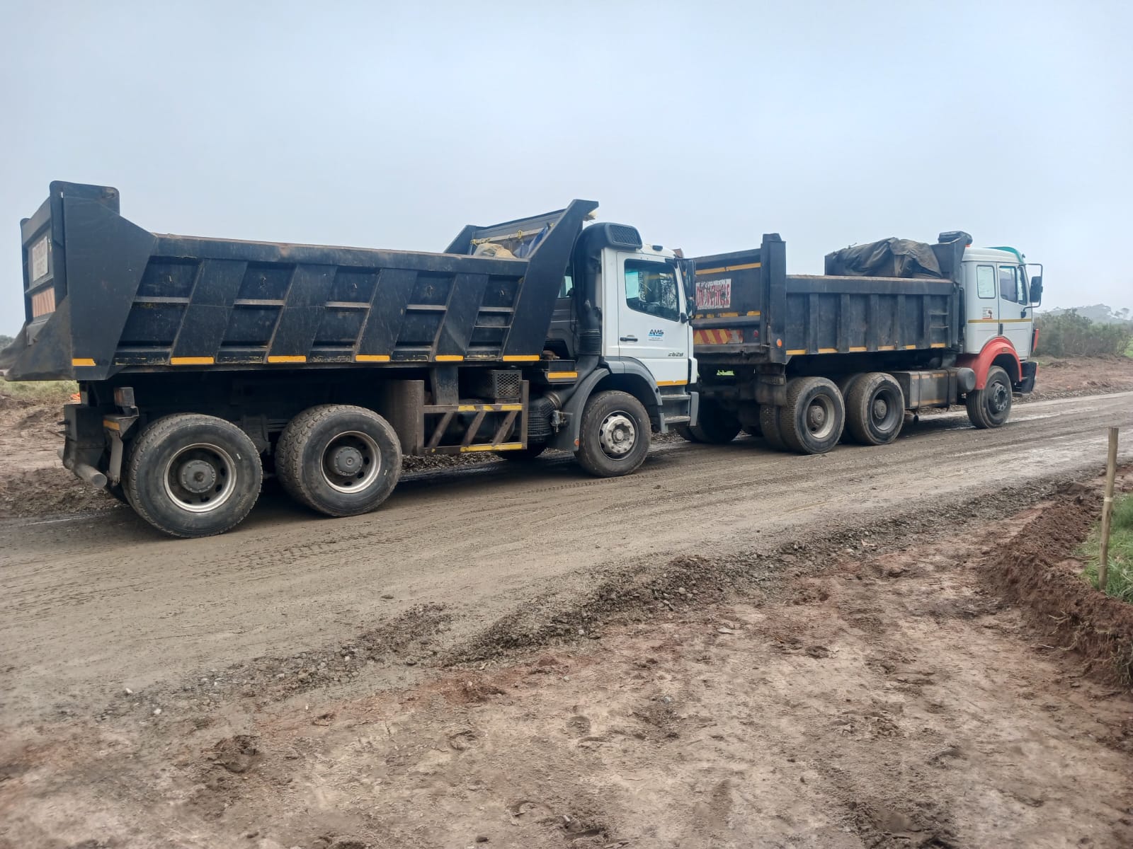 Two Excavator loading trucks