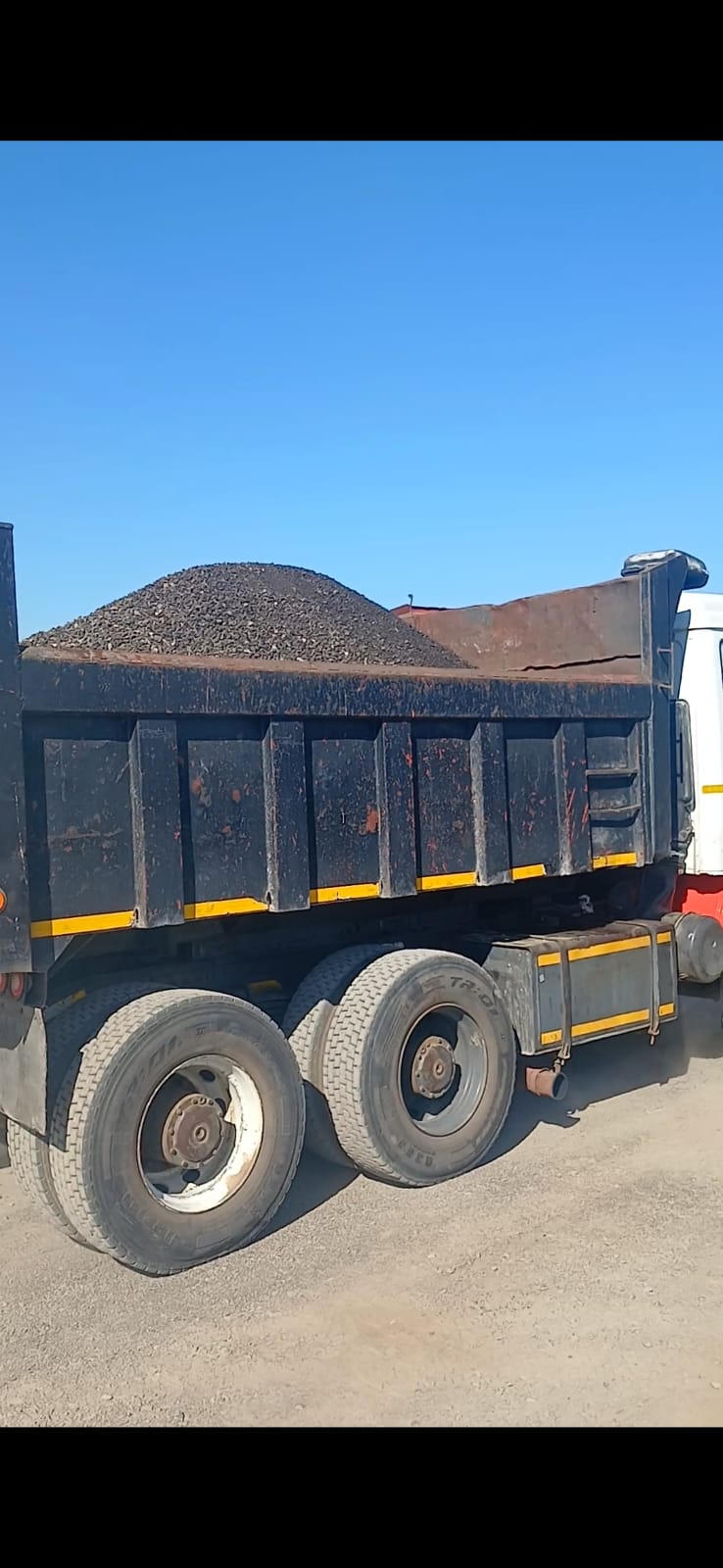 Excavator loading trucks